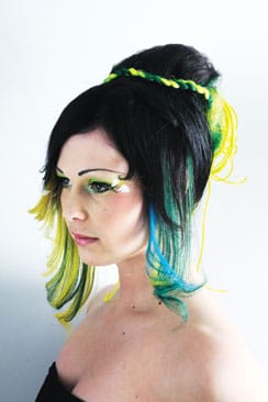 Villi Vaniljan kampaaja Mareena Vainio loihti Hannalle uutuuspään muotiväreillä. Kampaus on höystetty irtolisäkepunoksella. Petroolin- ja laguuninvihreät hiukset edessä ovat sinettejä, keltaiset ja vihreät takana on kiinnitetty ompelutekniikalla. Nis