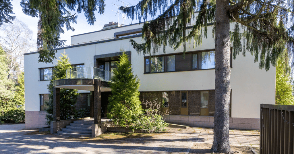 Kulosaaren luksustalon sisäänkäynti ja julkisivu – moderni kivitalo luonnon keskellä