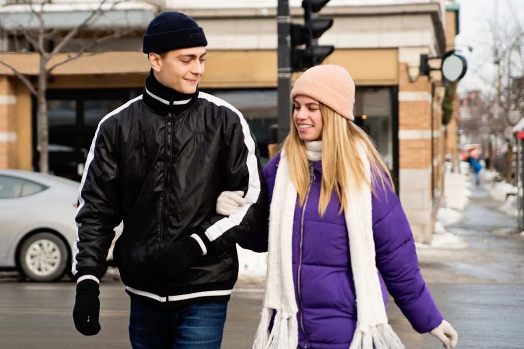 Nuoripari kävelee talvella tien yli pipot päässä pakkasella. Kuvituskuva Gen Z:tä käsittelevässä artikkelissa. 