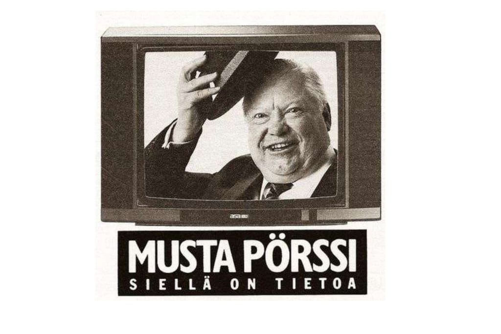 Vanha Musta Pörssi -mainos, jossa televisioruudussa esiintyy ketjun mainoshahmo Topi.
