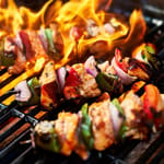 Kanakebabvartaat grillissä avotulen liekissä kesäillalla