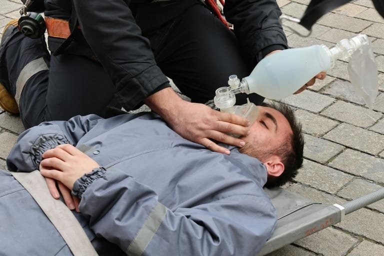 ensihoitaja antaa ensiapua miehelle kadulla hengityspalkeella päivystys seksivammat