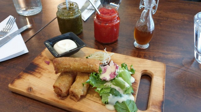 Filippiiniläinen sisig-possu tarjoillan Sentrossa rulliksi käärittyinä.